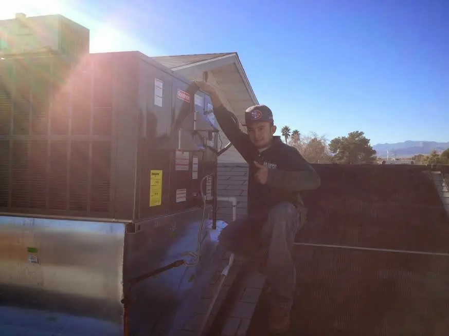 HVAC technician performing HVAC Inspection on a rooftop unit in Savannah